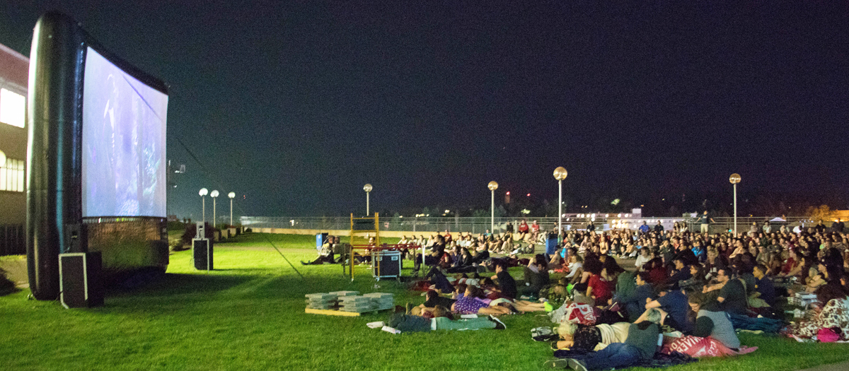 Students watch a movie outdoors on the Terrell Library rooftop