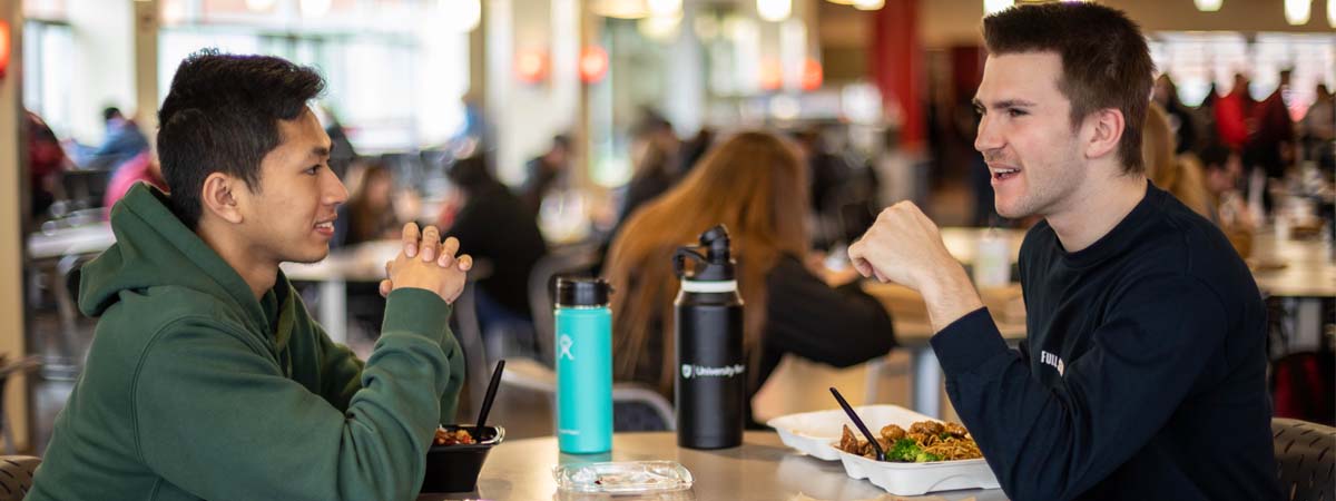 Two students eating in the Compton Union Building